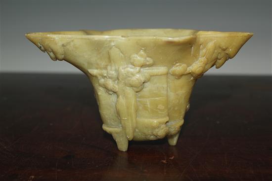 A Chinese pale green soapstone libation cup, 19th century, width 18.5cm, height 10cm, faults